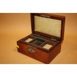 AN ANTIQUE LEATHER JEWELLERY BOX WITH KEY