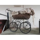 A REPRODUCTION WICKER DOLLS PRAM