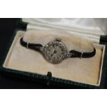 A LADIES VINTAGE PLATINUM AND DIAMOND SET WATCH - EACH BRILLIANT CUT DIAMOND APPROX 0.02 CARATS -