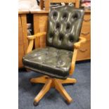 A MODERN GREEN LEATHER OFFICE SWIVEL ARMCHAIR