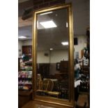 A LARGE MODERN GILT WALL MIRROR 165 CM X 75 CM