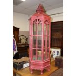 A LARGE RED LANTERN SHAPED DISPLAY FEATURE / CAGE WITH DRAWER BELOW