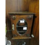 AN ANTIQUE OAK SMOKERS CABINET