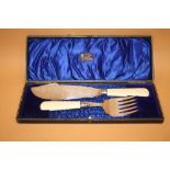 A CASED SET OF ANTIQUE FISH SERVERS