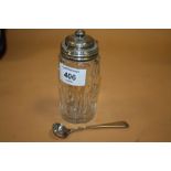 AN ANTIQUE HALLMARKED SILVER TOPPED CONDIMENT JAR AND CONDIMENT SPOON