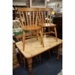 A HONEY PINE KITCHEN TABLE WITH FOUR TRADITIONAL STYLE CHAIRS