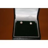 A PAIR OF 9CT GOLD DIAMOND SOLITAIRE STUD EARRINGS