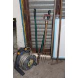 A HOSE REEL TOGETHER WITH FOUR GARDEN TOOLS