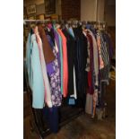 A RAIL OF LADIES VINTAGE CLOTHING' VARIOUS STYLES AND PERIODS TO INC 1970S AND 1980S ETC (APPROX 55)