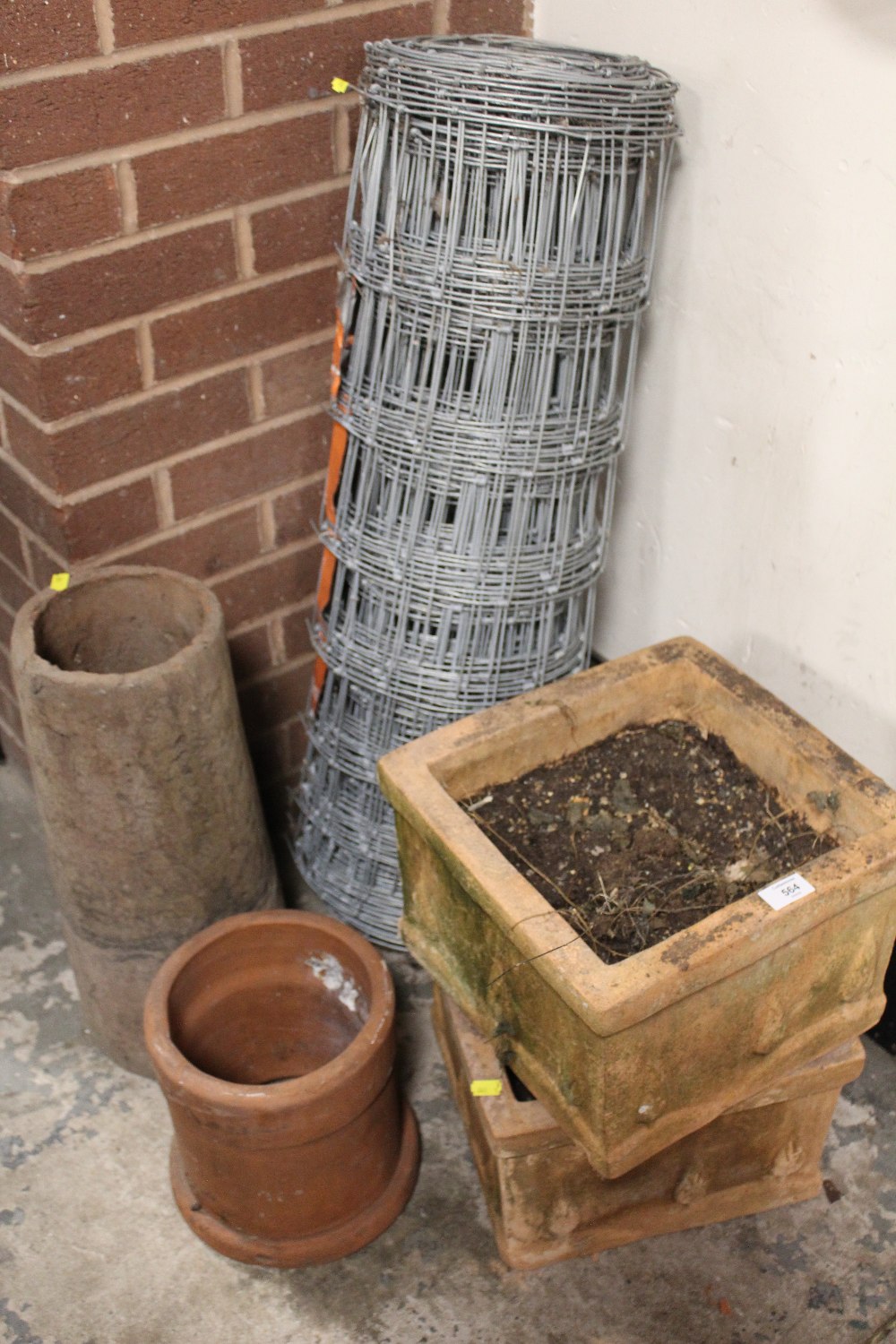 A ROLL OF WIRE FENCING TOGETHER WITH PLANTERS ETC