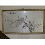 A GILT FRAMED AND GLAZED ORIENTAL NEEDLEWORK ON SILK DEPICTING A PEACOCK ON A BRANCH OVERALL SIZE