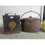 A VINTAGE CAST METAL COOKING POT AND A VINTAGE SHELL OIL CAN