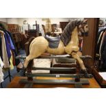 A MODERN CARVED AND PAINTED WOOD TRESTLE ROCKING HORSE OVERALL H-79 CM W-91 CM