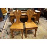 A PAIR OF SOLID OAK HALL STYLE CHAIRS