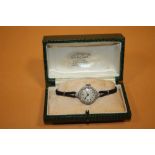 A LADIES VINTAGE PLATINUM AND DIAMOND SET WATCH - EACH BRILLIANT CUT DIAMOND APPROX 0.02 CARATS -