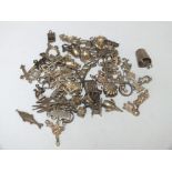 AN VINTAGE CHARM BRACELET COMPRISING APPROX 61 CHARMS