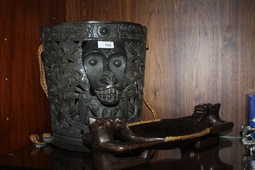 AN INDONESIAN TRIBAL ART DAYAK BORNEO BABY CARRIER TOGETHER WITH A TWIN HANDLED TREEN BOWL