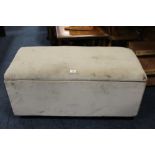 A MODERN UPHOLSTERED OTTOMAN