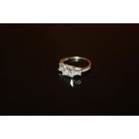 A LADIES 9 CARAT WHITE GOLD THREE STONE DRESS RING - SIZE K 1/2 - WEIGHT 2.1 GRAMS APPROX