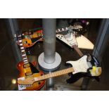 FOUR ORNAMENTAL MODERN MINIATURE GUITARS