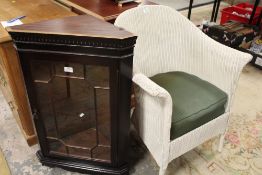 A REPRODUCTION MAHOGANY GLAZED HANGING CORNER CABINET WITH A LLOYD LOOM ARMCHAIR (2)