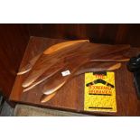 SIX AUSTRALIAN ABORIGINAL WOODEN BOOMERANGS TOGETHER WITH A BOOMERANG INFORMATION BOOK