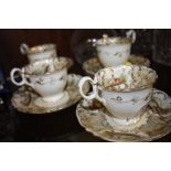A SET OF FOUR ANTIQUE HAND PAINTED CUPS AND SAUCERS DECORATED WITH COUNTRY SCENES PLUS ONE