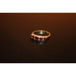 A HALLMARKED 9 CARAT GOLD FIVE STONE GARNET DRESS RING - SIZE N 1/2 - WEIGHT 2.3 GRAMS APPROX