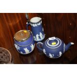 A WEDGWOOD BLUE DIP JASPERWARE TEAPOT, JUG AND CRACKER BARREL