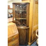 A REPRODUCTION MAHOGANY GLAZED CORNER CABINET