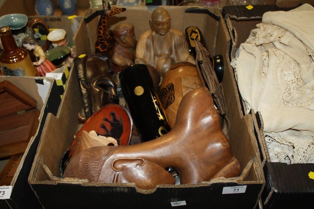 A TRAY OF TRIBAL STYLE CARVED TREEN ETC. TO INCLUDE A GIRAFFE FIGURE, WALL HANGING MASKS ETC.