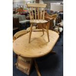 A PINE TWIN PEDESTAL EXTENDING DINING TABLE AND THREE CHAIRS