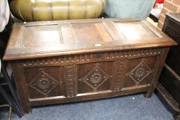 AN ANTIQUE OAK CARVED PANELED COFFER W-124 CM