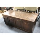 AN OAK PANELLED COFFER, W 126 CM