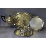 FIVE PIECES OF SILVER PLATED WARE, consisting of a teapot, trays and a champagne coaster, widest