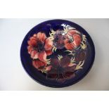 A MOORCROFT ANEMONE PATTERN CIRCULAR FOOTED BOWL, blue ground with typical tubelined decoration,