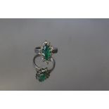 A HALLMARKED 18 CT WHITE GOLD EMERALD AND DIAMOND RING, the marquise cut emerald is surrounded by