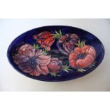 A MOORCROFT ANEMONE PATTERN OVAL DISH, blue ground with typical tubelined decoration, impressed