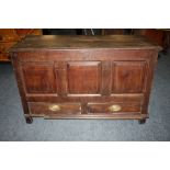 AN ANTIQUE OAK PANELLED MULE CHEST, the original hinged lid above a tripe panel front and two
