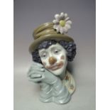 A LLADRO BUST OF A CLOWN, clasped hands to side of face, H 28.5 cm