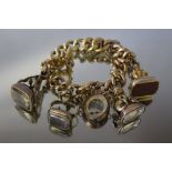 A GOLD FOB SEAL CHARM BRACELET, the bracelet stamp is indistinct but possibly 15ct, set with four