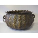 A 19TH CENTURY EASTERN BRONZE LOBED BOWL, having twin ring handles formed as elephant heads, the