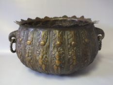 A 19TH CENTURY EASTERN BRONZE LOBED BOWL, having twin ring handles formed as elephant heads, the