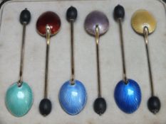 A CASED SET OF SIX ART DECO HALLMARKED SILVER AND GILT COFFEE BEAN SPOONS WITH GUILLOCHE ENAMEL