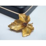 A HALLMARKED 9CT GOLD BROOCH IN THE FORM OF A LEAF, set with a small cluster of five gemstones, W