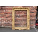 A 19TH CENTURY DECORATIVE GOLD SWEPT FRAME, frame W 14 cm, rebate approx 114 x 79 cm