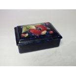 A MOORCROFT POMEGRANATE PATTERN RECTANGULAR LIDDED BOX, with typical tubelined decoration, paper