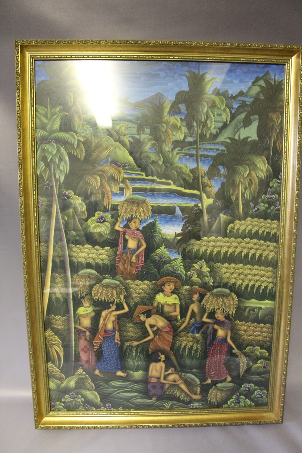 A 20TH CENTURY BALINESE PAINTING OF A VILLAGE SCENE, mixed media and textile, signed lower right, - Image 2 of 5