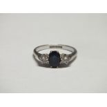 A SAPPHIRE AND DIAMOND THREE STONE RING, the brilliant cut diamonds being an estimated 10pts each,