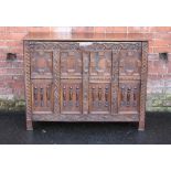 AN ANTIQUE OAK JACOBEAN STYLE DEEP COFFER, the hinged lift-up lid above a carved and